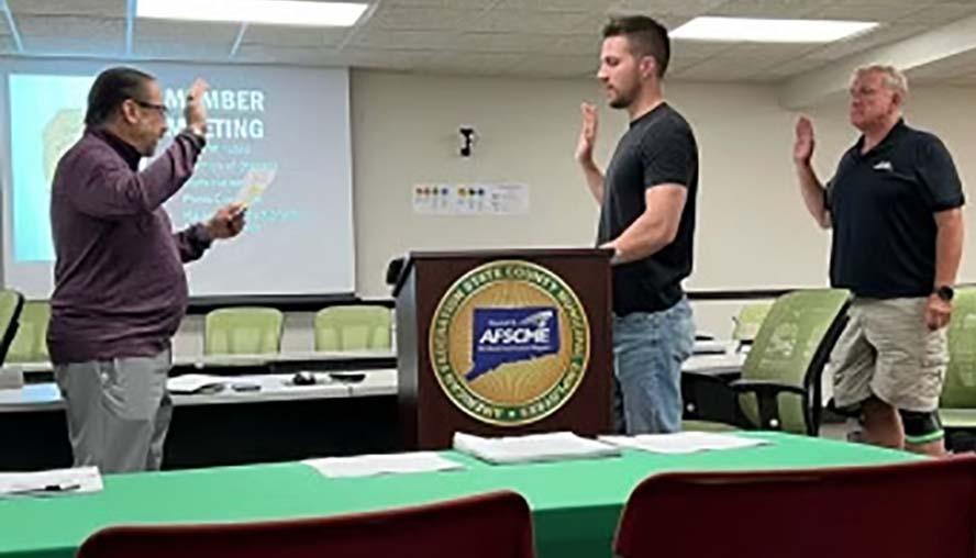 The late Bob Parziale, left, swears in Local 2193 President Brian Mezick, middle, and Vice President Michael DeLorenzo at the the union's June 14 meeting.